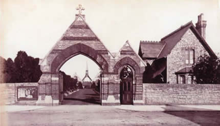 The cemetery gates, the Lodge, the central driveway and the two chapels with the covered porch and bell tower